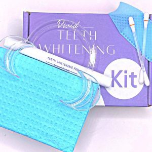 Vivid Teeth Whitening kit with whitening pen, cheek retractor and dental bib.