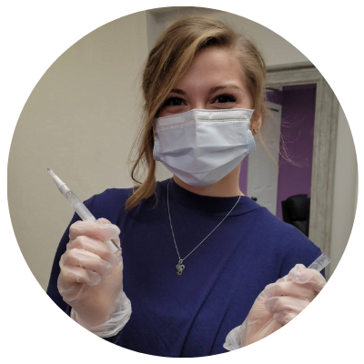 Image of Abby holding professional teeth whitening gel pen.